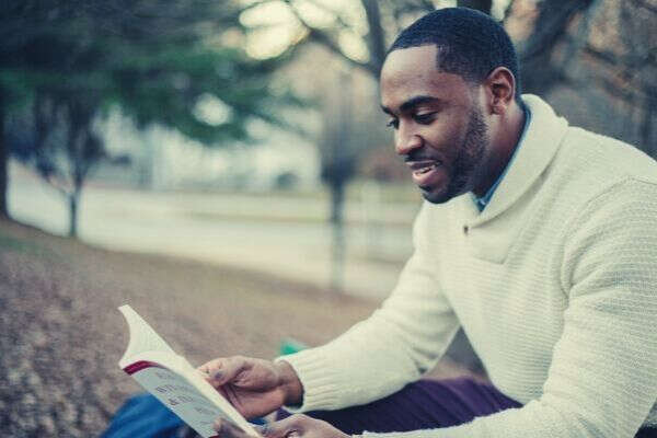 black-american-smiling-long-sleeves-reading-book