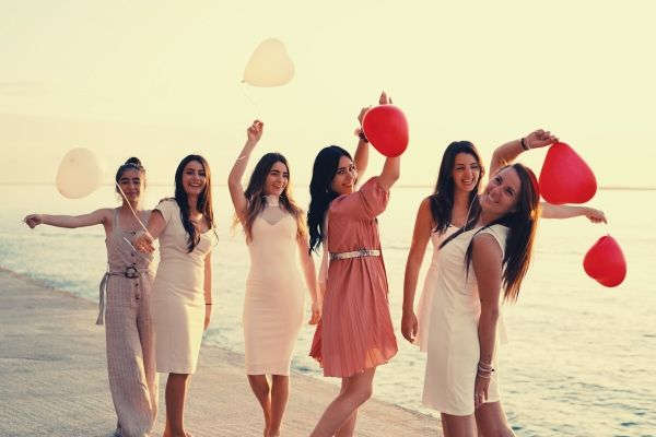 group-of-women-holding-balloons-sea