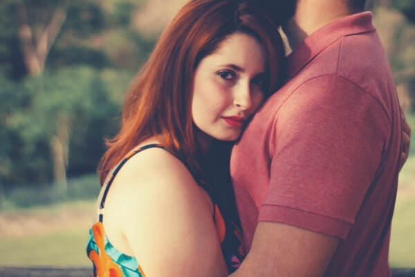 09-feature-woman-hugging-man-looking-on-the-camera