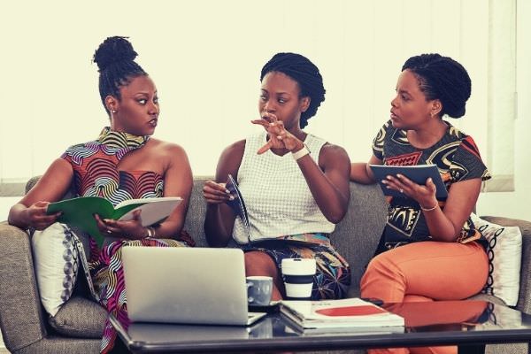 three-black-women-talking-to-each-other-words-to-describe-company-culture