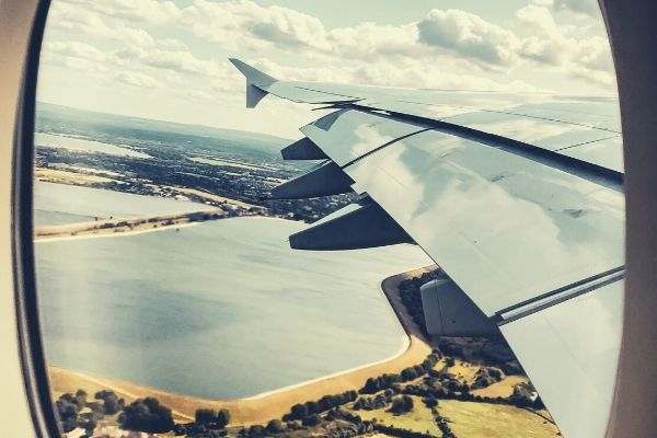 airplane-window-seat-view-flight-sky-and-field