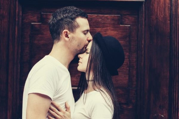 man-and-woman-in-white-shirt-man-kissing-the-girl-s-forehead-woman-encourage-boyfriend
