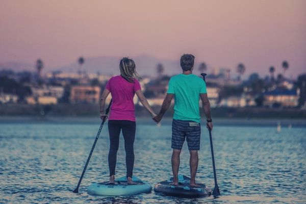 man-and-woman-standing-on-a-paddle
