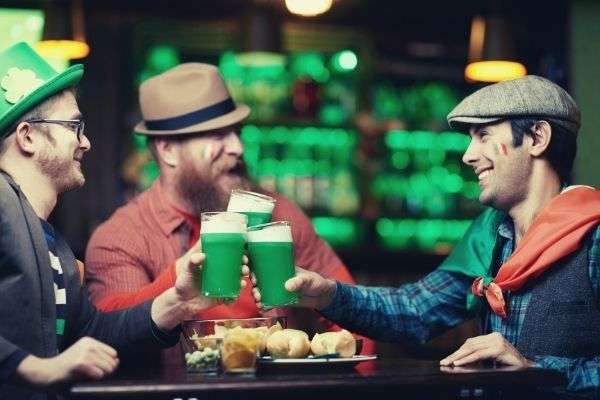 friends-at-a-bar-cheering-Saint-Patrick-s-Day-caption
