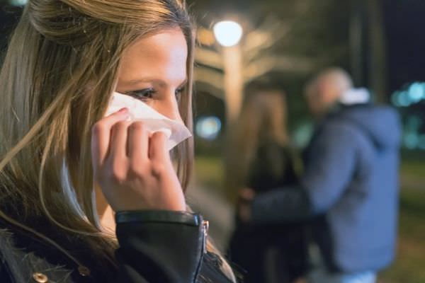 what to say when someone betrayed you woman crying wiping with tissue