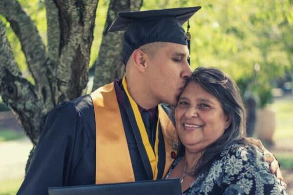 man-graduate-kiss-mommy-smiling